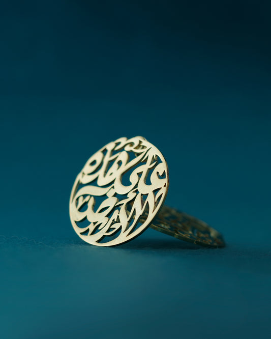 Gold earring with intricate design on a blue background